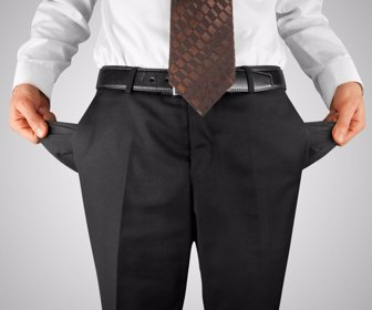 26576663 - bankrupt business man showing empty pockets hands