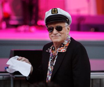 FILE PHOTO - Hugh Hefner, founder of Playboy magazine, twirls a napkin during a performance by Dr. John and the Lower 911 at the 30th annual Playboy Jazz Festival at the Hollywood Bowl in Hollywood, California