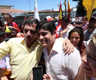 Carlos Alvarado Quesada, presidential candidate of the ruling Citizens' Action Party, takes a photo with a supporter after casting his ballot during the presidential election in San Jose