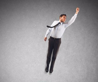 Businessman uses a spring to make leap