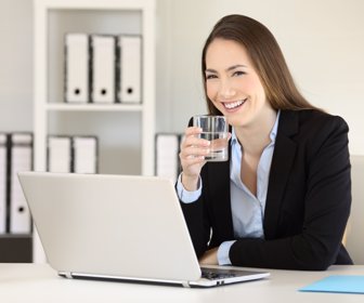 Executive holding a glass of water and looking at you