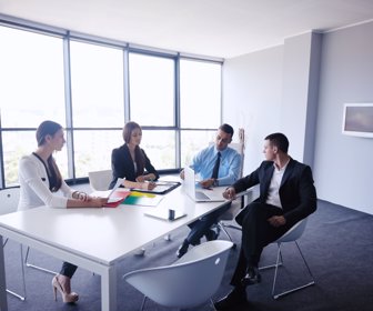 Group of happy young business people in a meeting at office