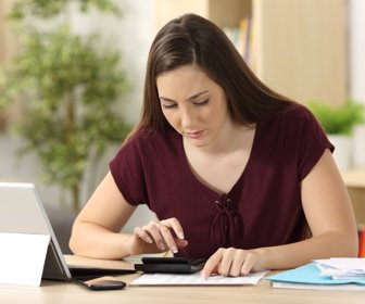 Woman calculating accountancy with a calculator