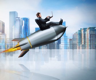Fast internet concept with a businessman with laptop over a speedy rocket