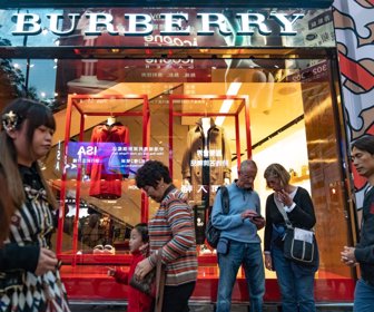 Tourists walk past a Burberry store in Hong Kong, China, on Sunday Feb 3, 2019.